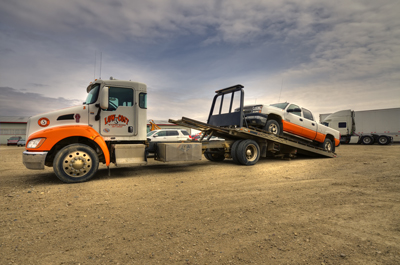 Wrecker truck carrying car